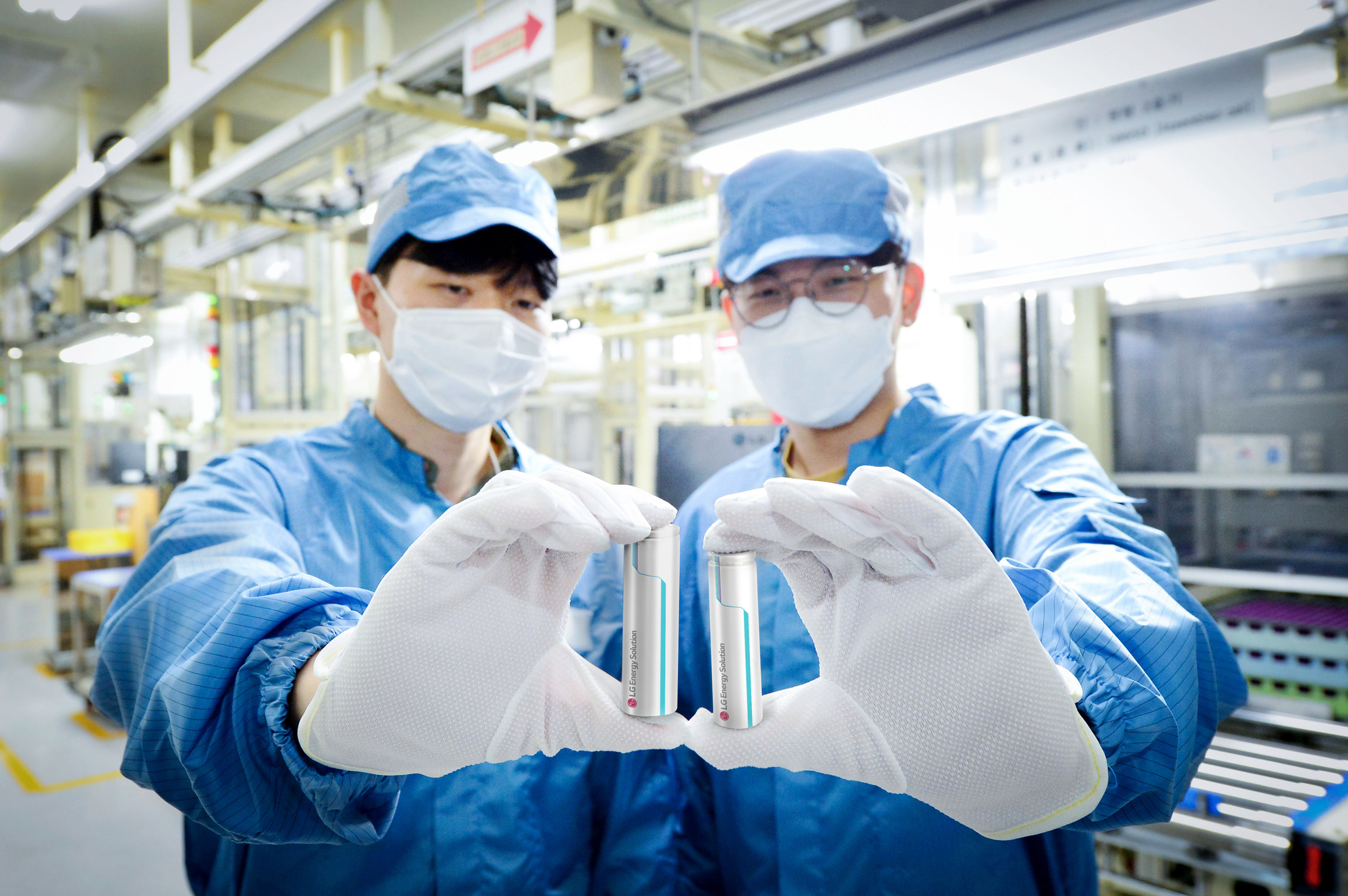 LG Energy Solution employees pose with the company's cylindrical batteries. [LG ENERGY SOLUTION]