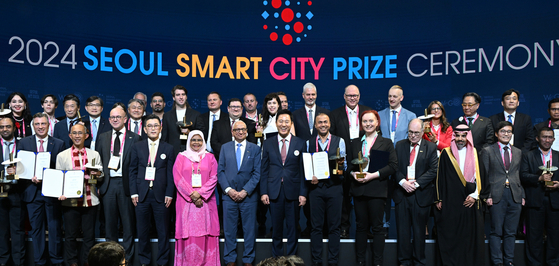 Seoul Mayor Oh Se-hoon, center, and recipients of this year's Seoul Smart City Prize pose for a photo during the awards ceremony at COEX in southern Seoul on Thursday. [SEOUL METROPOLITAN GOVERNMENT] 