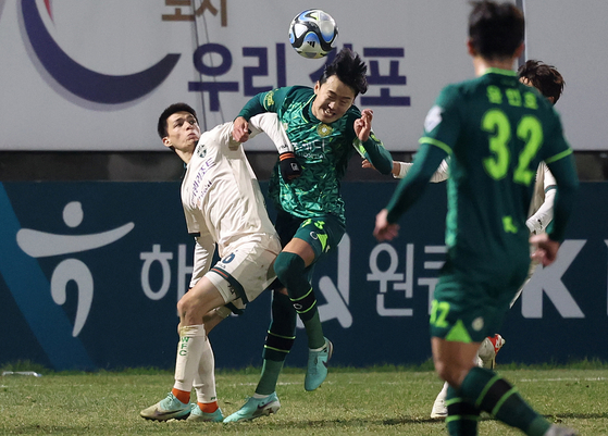 Gimpo FC, in green, play the K League promotion-relegation playoff against Gangwon FC at Gimpo Solteo Football Field in Gimpo, Gyeonggi on Dec. 6, 2023. [NEWS1] 