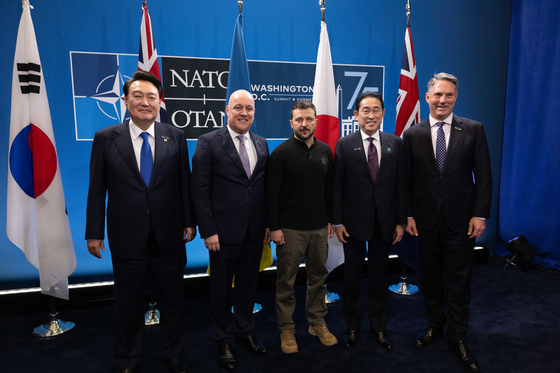 Korean President Yoon Suk Yeol, left, poses with other IP4 leaders and Ukrainian President Volodymyr Zelenskyy, center, at the NATO summit in Washington on July 11. IP4 refers to NATO's four Indo-Pacific partners: South Korea, Japan, Australia and New Zealand. From left are Yoon, Christopher Luxon of New Zealand, Zelensky, Fumio Kishida of Japan and Richard Marles of Australia. [PRESIDENTIAL OFFICE] 