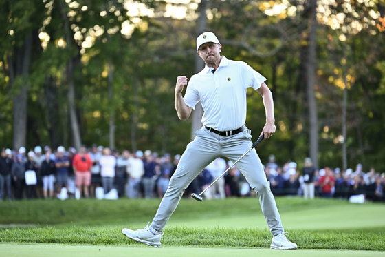 Mackenzie Hughes of the International Team reacts to making a birdie putt on the 16th hole on day three of the 2024 Presidents Cup at The Royal Montreal Golf Club on Sept. 28 in Montreal, Quebec. [PGA TOUR]