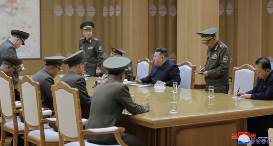 North Korea's leader Kim Jong-un, third from right, convenes a consultative meeting on national defense and security on Monday to discuss ways to respond to South Korean drones' alleged flights over Pyongyang. [KOREAN CENTRAL NEWS AGENCY]