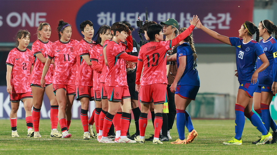 The Korean women's football team, in red, reacts after winning a friendly match against the Philippines at Icheon Sports Complex in Icheon, Gyeonggi on April 8. [NEWS1] 