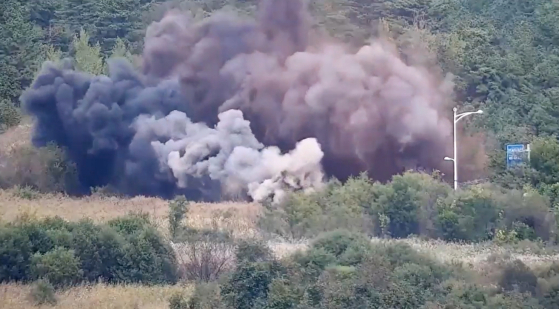 Surveillance camera footage taken by the South Korean military shows a road section north of the border along the Donghae line on the eastern coast being detonated by the North Korean military on Tuesday. [JOINT CHIEFS OF STAFF]