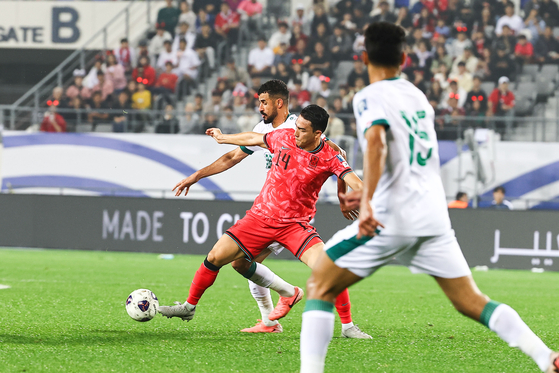 Korea's Cho Yu-min, center, vies for the ball during a 2026 World Cup qualifer against Iraq at Yongin Mireu Stadium in Yongin, Gyeonggi on Tuesday. [JOONGANG ILBO] 