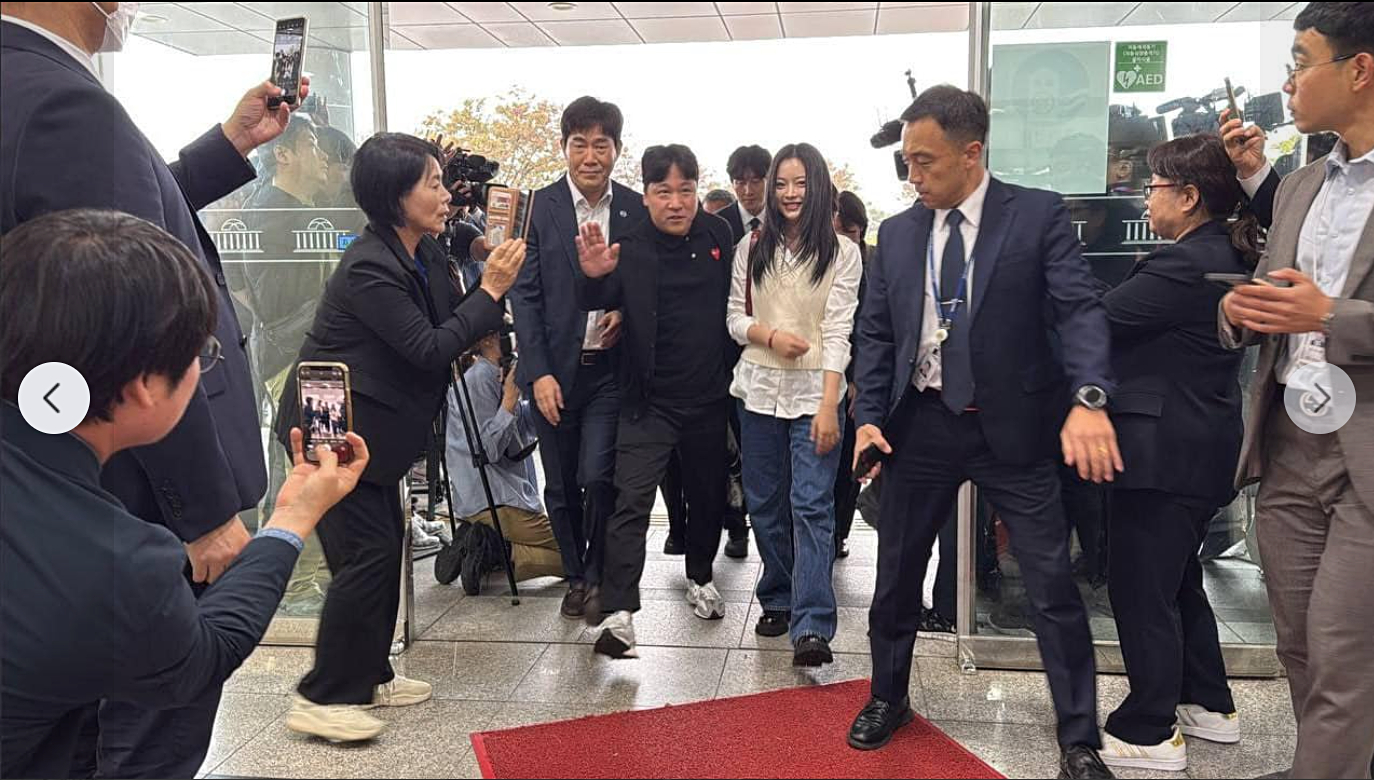 Democratic Party Rep. Choi Min-hee, third from left, films Hanni as she enters the National Assembly building on Tuesday. (NEWS1)