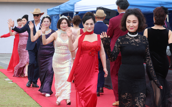 Participants rehearse for a senior model fashion show, a component of the 2024 Busan 50+ Job Fair, at Busan Citizens Park in Busanjin District, Busan, on Thursday morning. [YONHAP]