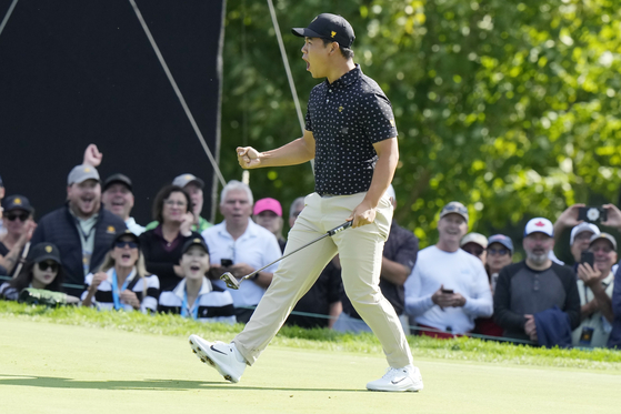 International team member Tom Kim celebrates a birdie putt on the seventh hole during a first round four-ball match at the Presidents Cup golf tournament at the Royal Montreal Golf Club in Montreal on Sept. 26. [AP/YONHAP]