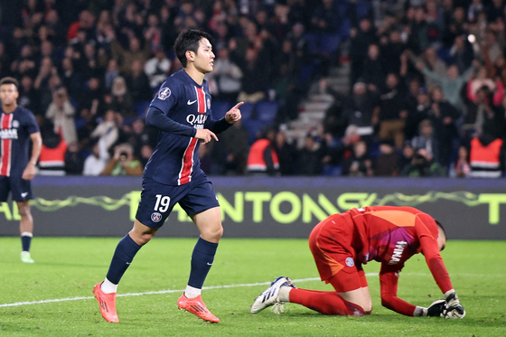 Paris Saint-Germain midfielder Lee Kang-in, left, celebrates scoring during a Ligue 1 match against Strasbourg in Paris on Saturday. [EPA/YONHAP] 