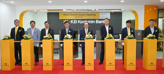 KB Kookmin Bank officials pose for a photo during an opening ceremony at its Pune branch in India on Oct. 16. [KB KOOKMIN BANK]