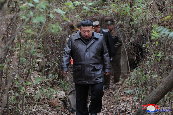 North Korean leader Kim Jong-un walks along a forest path to a strategic missile base in this undated photo provided by the North's official Korean Central News Agency on Wednesday. [YONHAP]